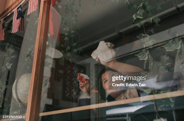 asian down sydrome female waitress cleaning wet wipe window at cafe - restaurant cleaning stock pictures, royalty-free photos & images