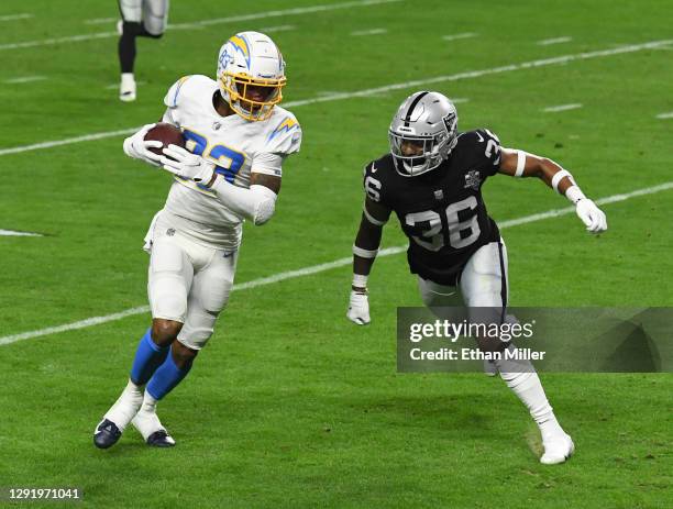 Wide receiver Tyron Johnson of the Los Angeles Chargers scores a touchdown on a 26-yard pass play against cornerback Daryl Worley of the Las Vegas...