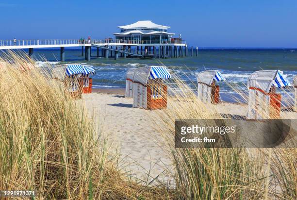 seabridge timmendorfer strand with many beach chairs (timmendorfer strand, schleswig-holstein, germany) - schleswig holstein stock pictures, royalty-free photos & images