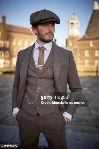 a cool man wearing a tweed suit and a flat cap - flat cap stock pictures, royalty-free photos & images