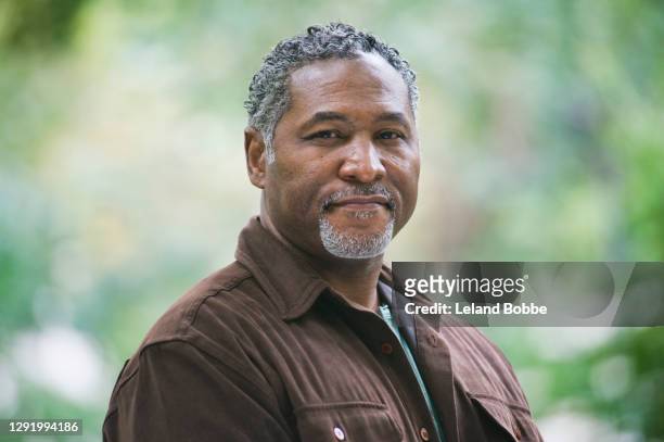 portrait of mixed race middle aged man - mature men stock pictures, royalty-free photos & images
