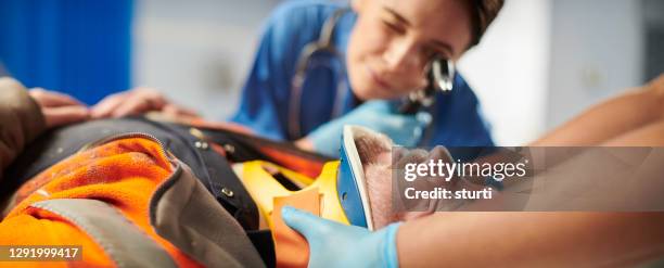 injured building contractor in hospital - cervical collar stock pictures, royalty-free photos & images