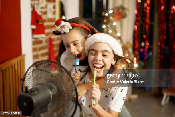 girls in a lot of heat at christmas - christmas singing stock pictures, royalty-free photos & images