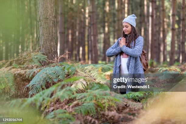 female hiker doing yoga while standing in cannock chase woodland - cannock wood stock pictures, royalty-free photos & images