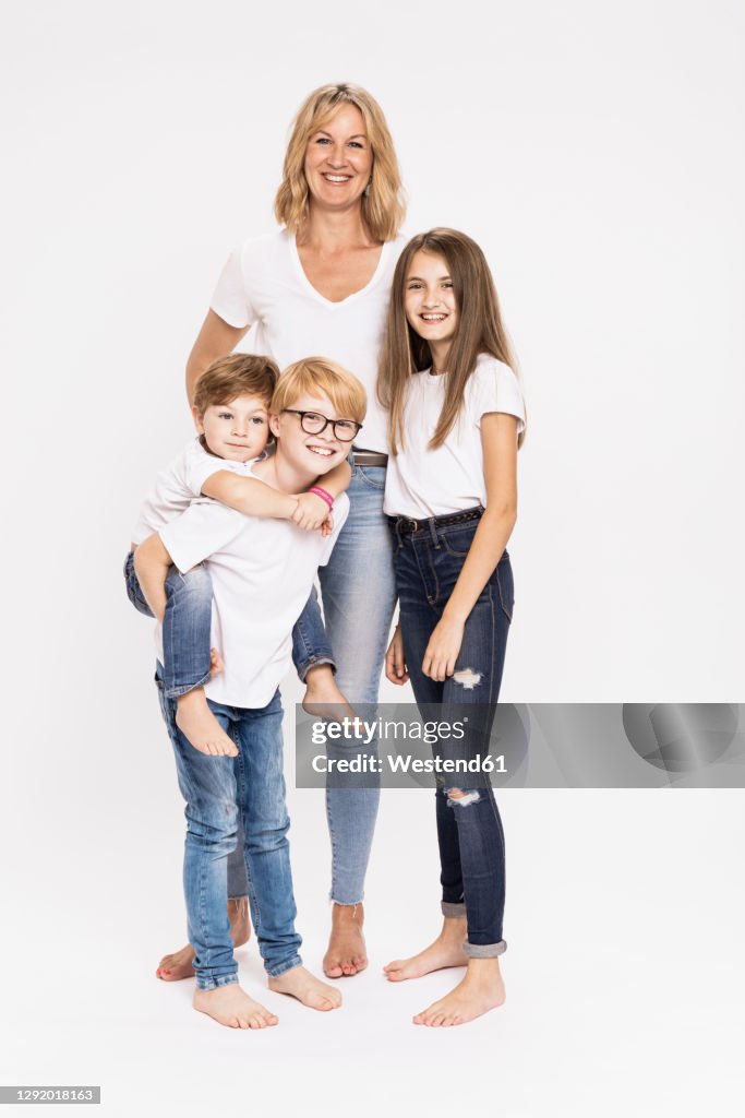 Happy mature woman with children against white background