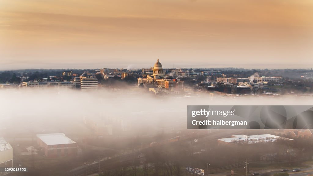 Freight Train Moving Through Fog Near Arkansas State Capitol - Aerial