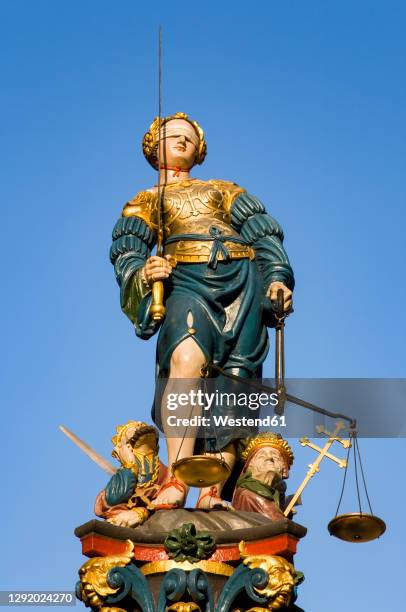 switzerland, canton of bern, bern, statue of lady justice standing on top of gerechtigkeitsbrunnen fountain - lady justice statue stock pictures, royalty-free photos & images