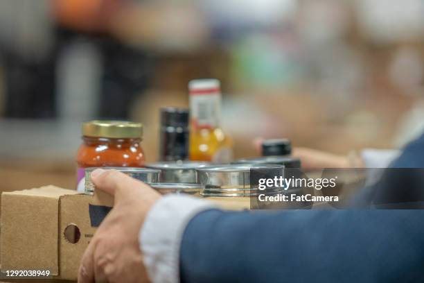 volunteer carrying non-perishable goods - food drive stock pictures, royalty-free photos & images