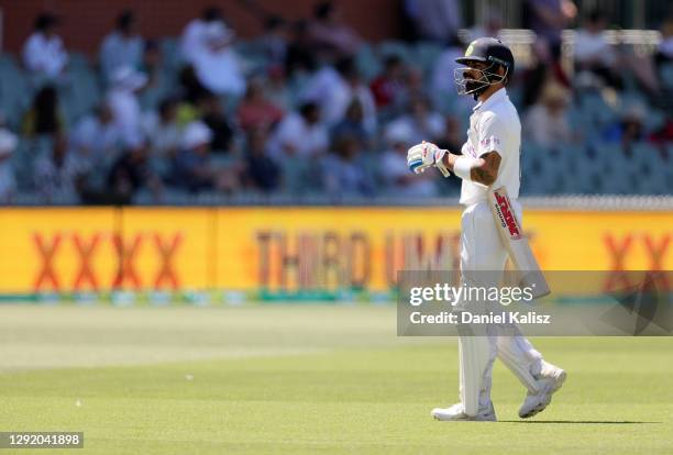 Virat Kohli of India walks from the ground after being dismissed during day three of the First Test match between Australia and India at Adelaide...