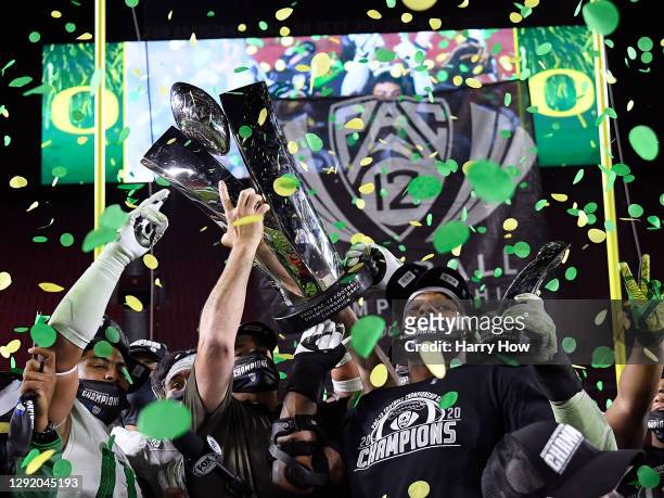 Head coach Mario Cristobal hoists the trophy, with most valuable player, Kayvon Thibodeaux of the Oregon Ducks, in celebration a 31-24 win over the...