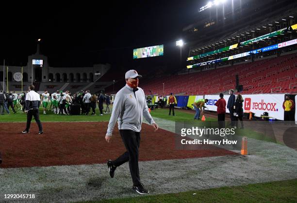 Head coach Clay Helton of the USC Trojans walk off the field after a 31-24 loss to the Oregon Ducks during the PAC 12 2020 Football Championship at...