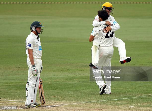 James Faulkner of the Tigers looks after being caught as Mitchell Johnson and Marcus Harris of the Warriors celebrate during day four of the...