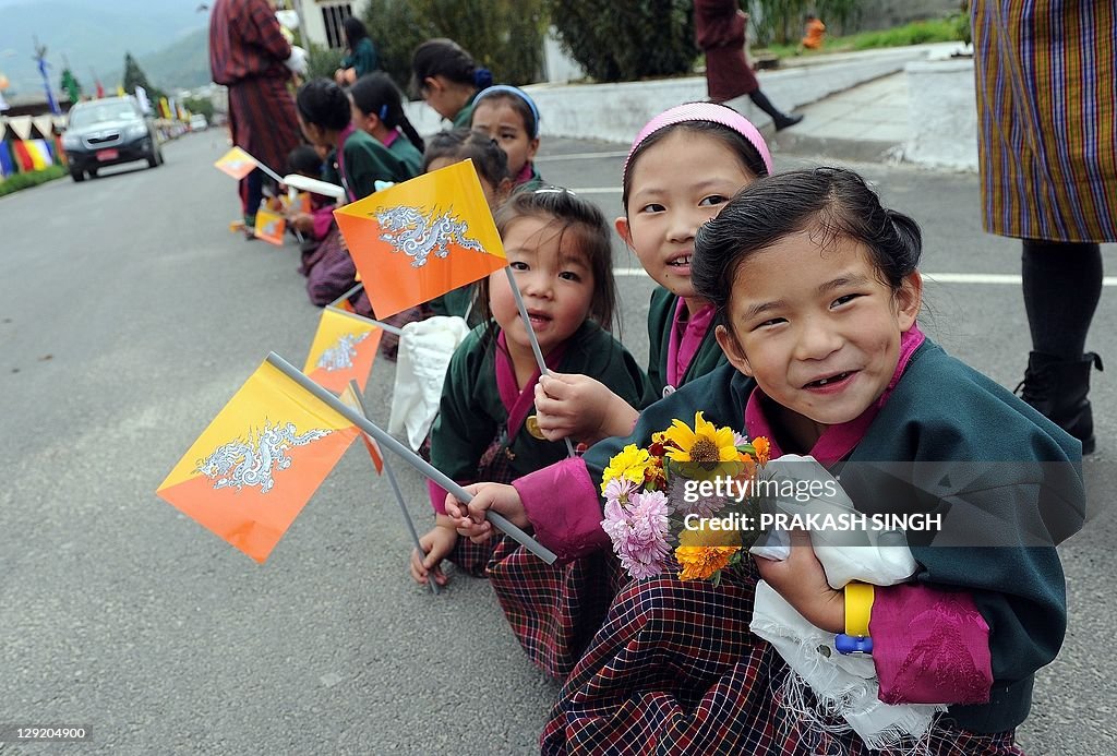 Bhutanese school children wave the natio