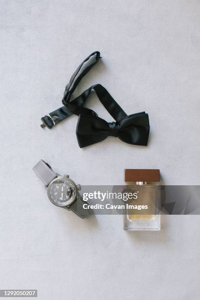 groom accessories. wristwatch, bow tie and perfume. - dress code stock pictures, royalty-free photos & images
