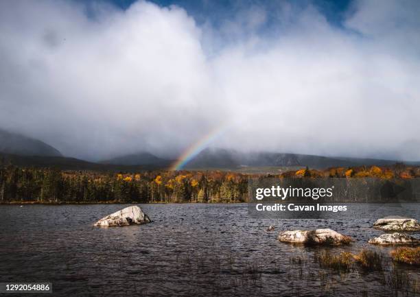 rainbow forms over sandy stream pond, baxter state park, maine - baxter state park stock pictures, royalty-free photos & images