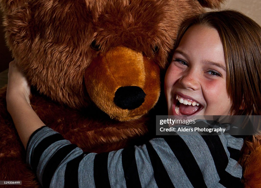 Portrait of boy hugging teddy bear