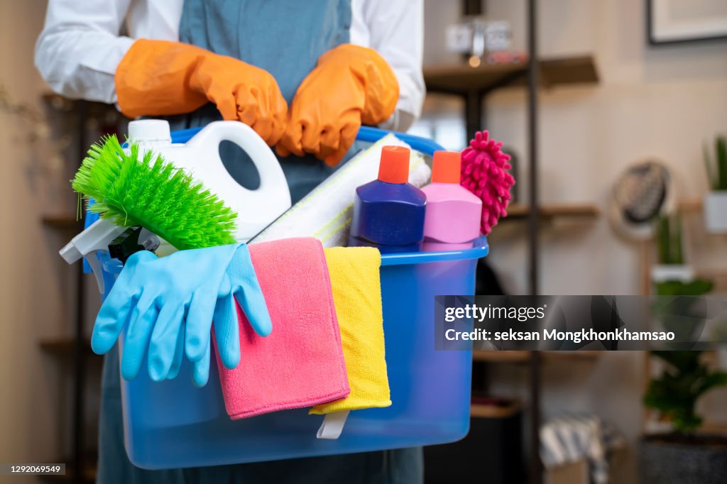 Woman holding cleaning products