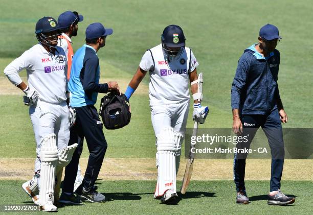 Umesh Yadav of India watches Mohammed Shami of India retire hurt to end India's second innings all out for 36 during day three of the First Test...