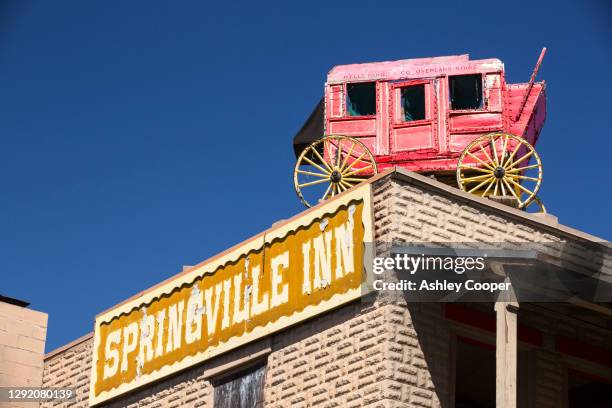 an old wells fargo mail wagon on the roof of the springvile inn, in sprinville, near porterville, california, usa. - springville california stock pictures, royalty-free photos & images