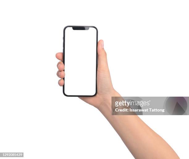 close up hand hold phone isolated on white background - smartphone stock-fotos und bilder