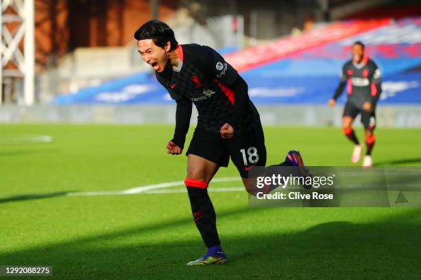 Takumi Minamino of Liverpool celebrates after scoring their sides first goal during the Premier League match between Crystal Palace and Liverpool at...