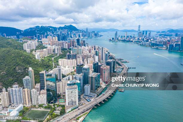 aerial view of victoria harbour, focus on the east side of hong kong island - leste imagens e fotografias de stock