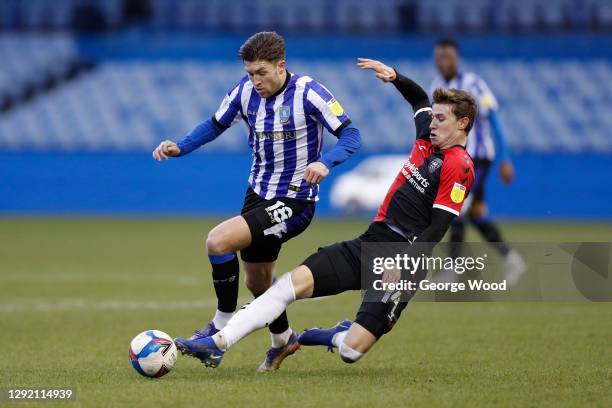 Josh Windass of Sheffield Wednesday is challenged by Ben Sheaf of Coventry City during the Sky Bet Championship match between Sheffield Wednesday and...