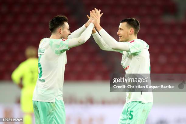 Kevin Moehwald and Maximilian Eggestein of Werder Bremen celebrate after the Bundesliga match between 1. FSV Mainz 05 and SV Werder Bremen at Opel...