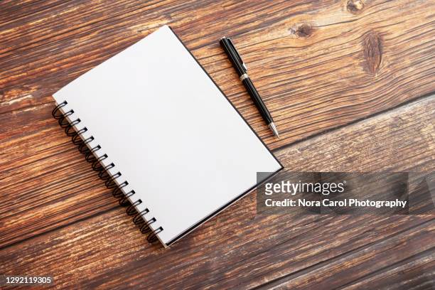 notepad with pen on wooden background - notepad white table foto e immagini stock