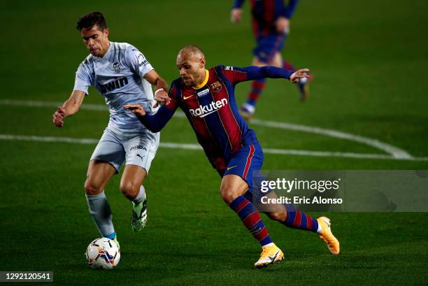 Martin Braithwaite of Barcelona is put under pressure by Gabriel Paulista of Valencia during the La Liga Santander match between FC Barcelona and...