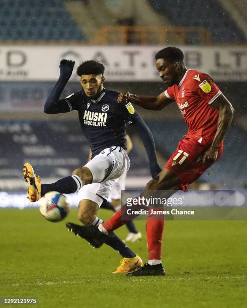 Sammy Ameobi of Nottingham Forest is challenged by Tyler Burey of Millwall during the Sky Bet Championship match between Millwall and Nottingham...