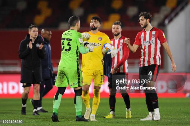 David Raya and Charlie Goode of Brentford embrace Rafael Cabral Barbosa of Reading at full-time after the Sky Bet Championship match between...