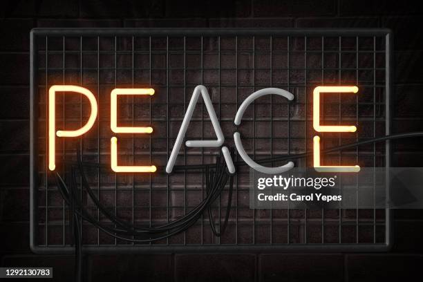 peace single word in neon lights - typographies stock-fotos und bilder