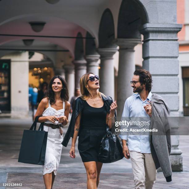 friends walk through commercial district in european city - lugano switzerland stock pictures, royalty-free photos & images