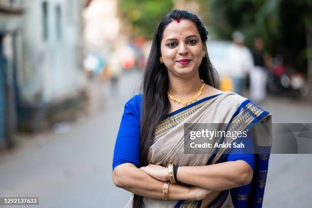 outdoor waist up portrait of a beautiful woman with crossed arms. - india sari stock pictures, royalty-free photos & images