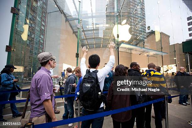 People wait in line for Apple's new iPhone 4s at the Apple Store on Broadway and 67th Street on October 14, 2011 in New York City. The new phone,...