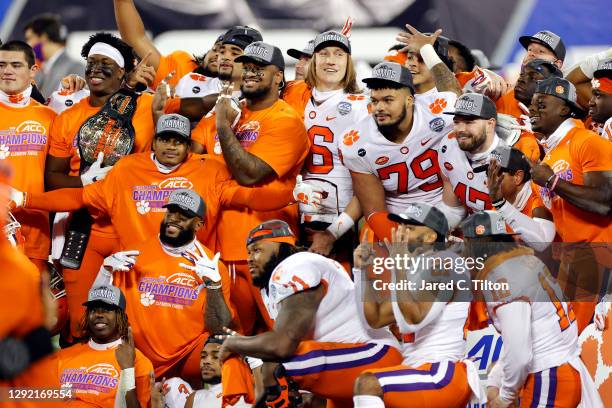 Clemson Tigers players pose after defeating the Notre Dame Fighting Irish 34-10 in the ACC Championship game at Bank of America Stadium on December...