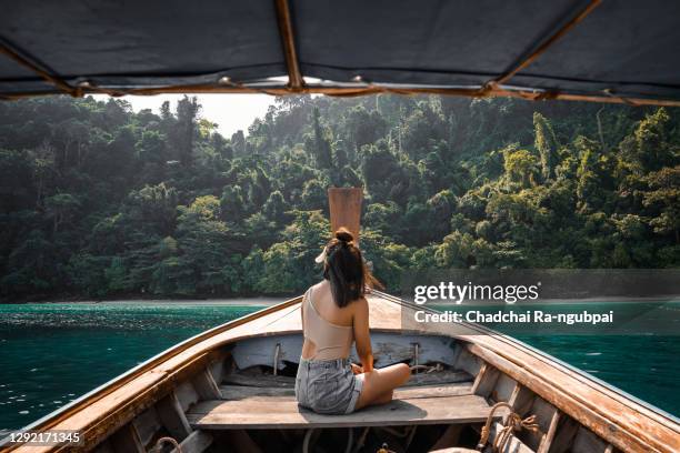 tourists young asian woman on long tailed boat at koh phi phi island, phuket, thailand. - thailand stock pictures, royalty-free photos & images