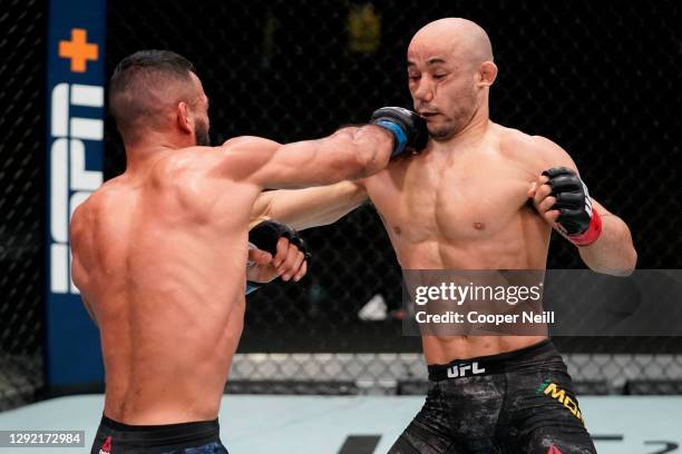 Rob Font punches Marlon Moraes of Brazil in a bantamweight fight during the UFC Fight Night event at UFC APEX on December 19, 2020 in Las Vegas,...