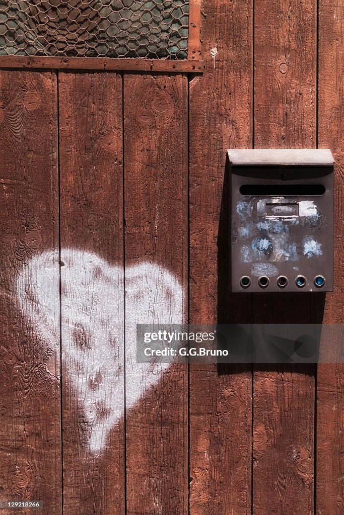 Iron mailbox on wooden doo