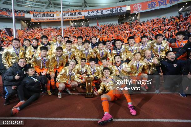 Players of Shandong Luneng Taishan celebrate with champion trophy after winning the 2020 Chinese Football Association Cup final match between Jiangsu...