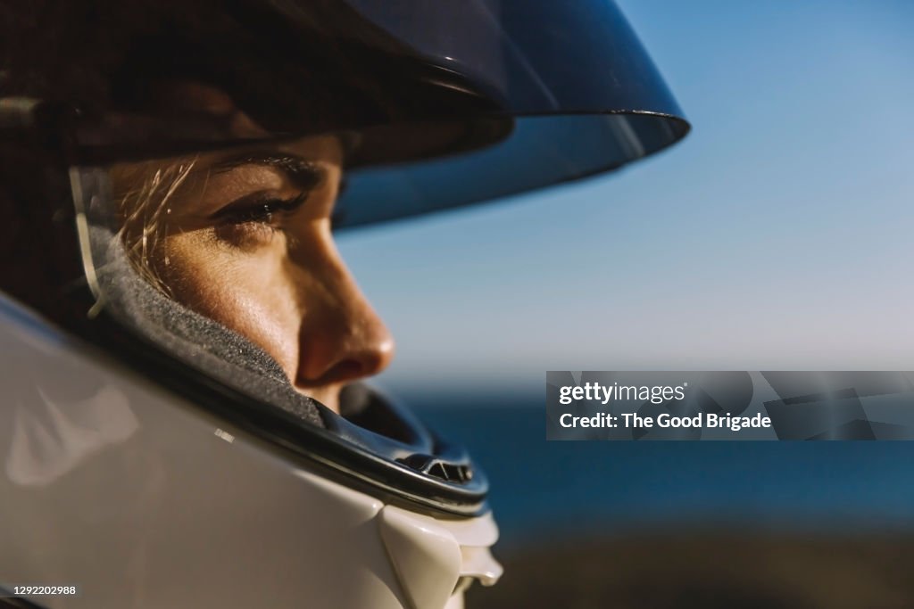 Close-up of woman wearing motorcycle helmet