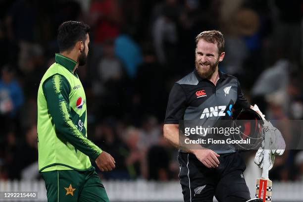 Shadab Khan captain of Pakistan speaks to Kane Williamson, captain of New Zealand at the end of the match during game two of the International T20...