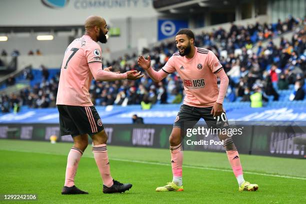 Jayden Bogle of Sheffield United celebrates with David McGoldrick after scoring their sides first goal during the Premier League match between...