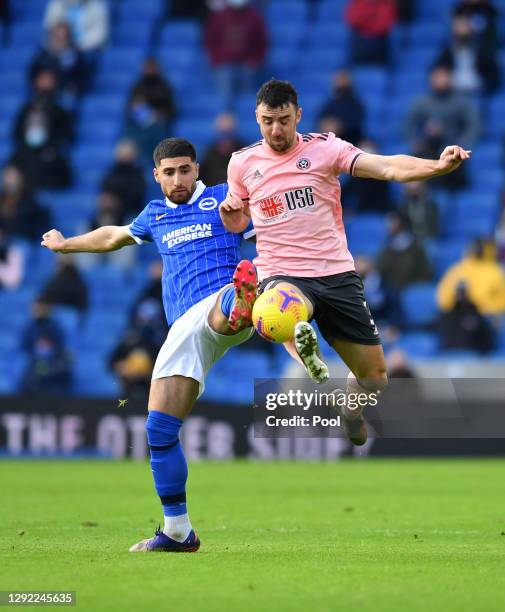 Alireza Jahanbakhsh of Brighton & Hove Albion battles for possession with Enda Stevens of Sheffield United during the Premier League match between...