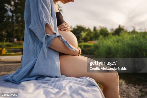 future mother on summer vacation - pregnancy stock pictures, royalty-free photos & images