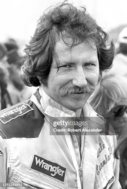 Driver Dale Earnhardt Sr. Stands beside his racecar prior to the start of the 1981 Daytona 500 stock car race at Daytona International Speedway in...