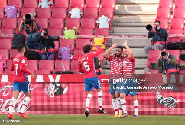 Roberto Soldado of Granada CF celebrates with team mates Yangel Herrera and Luis Milla after scoring their sides second goal during the La Liga...