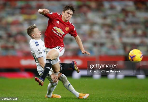 Ezgjan Alioski of Leeds United tackles Daniel James of Manchester United during the Premier League match between Manchester United and Leeds United...