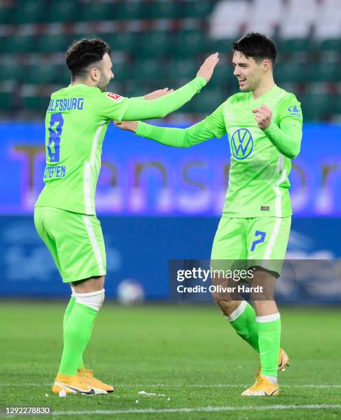 Josip Brekalo of Vfl Wolfsburg celebrates with team mate Renato Steffen after scoring their sides first goal during the Bundesliga match between VfL...